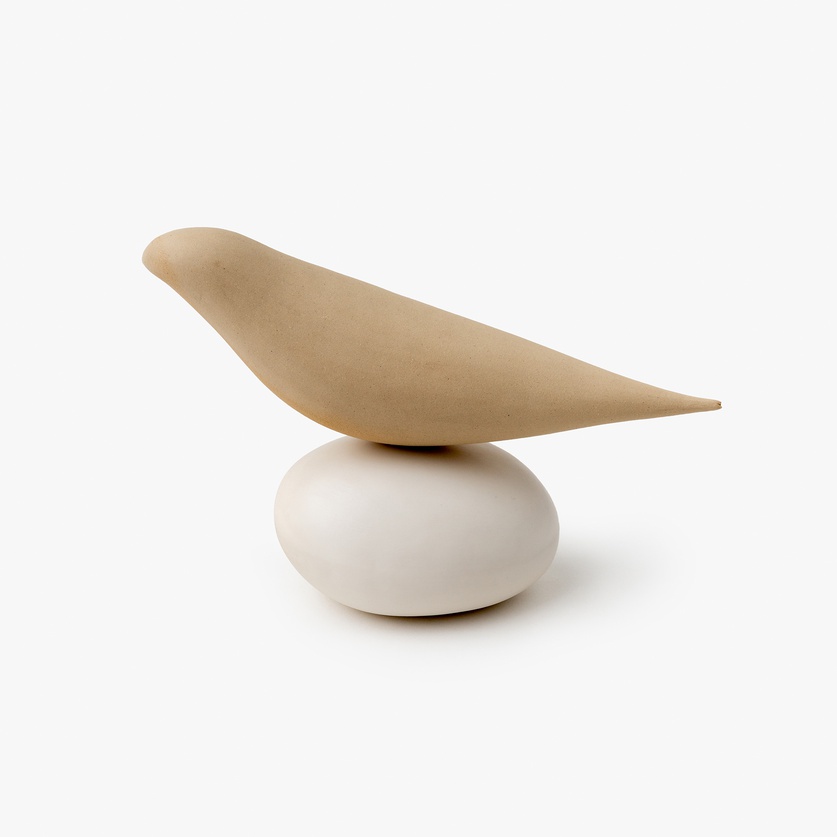 Little ceramic bird on a porcelain base