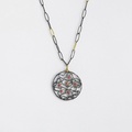 Impressive round pendant in silver and gold inlay with rubies