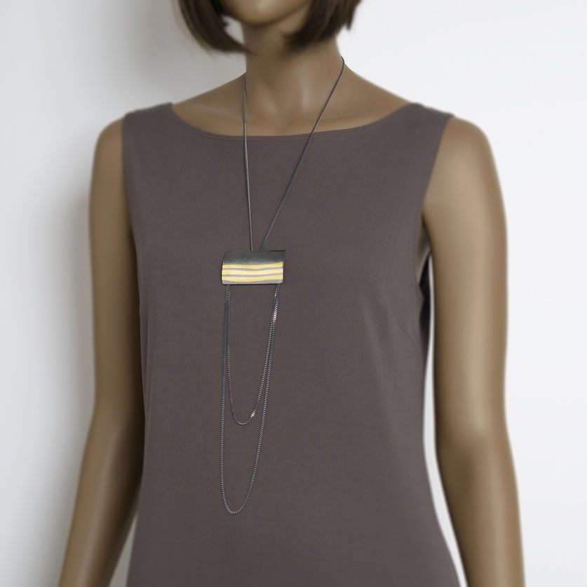 Modern rectangular necklace in silver and gold with chains