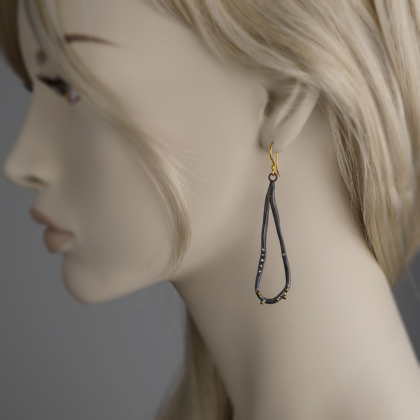 Abstract-shaped earrings in silver and gold with diamonds