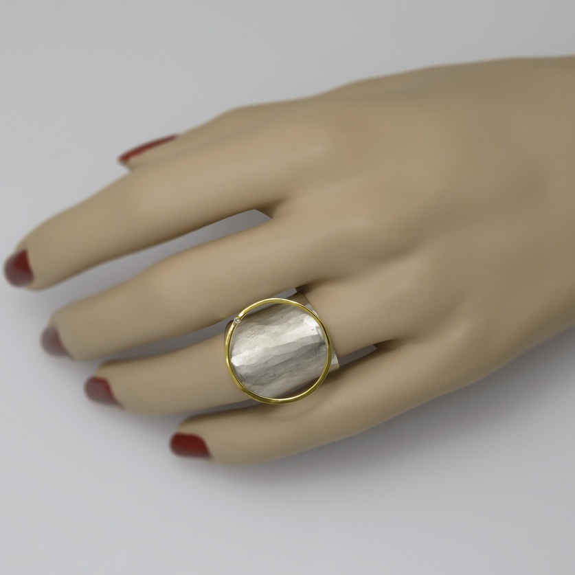White silver ring of modern design with circle of gold and diamond