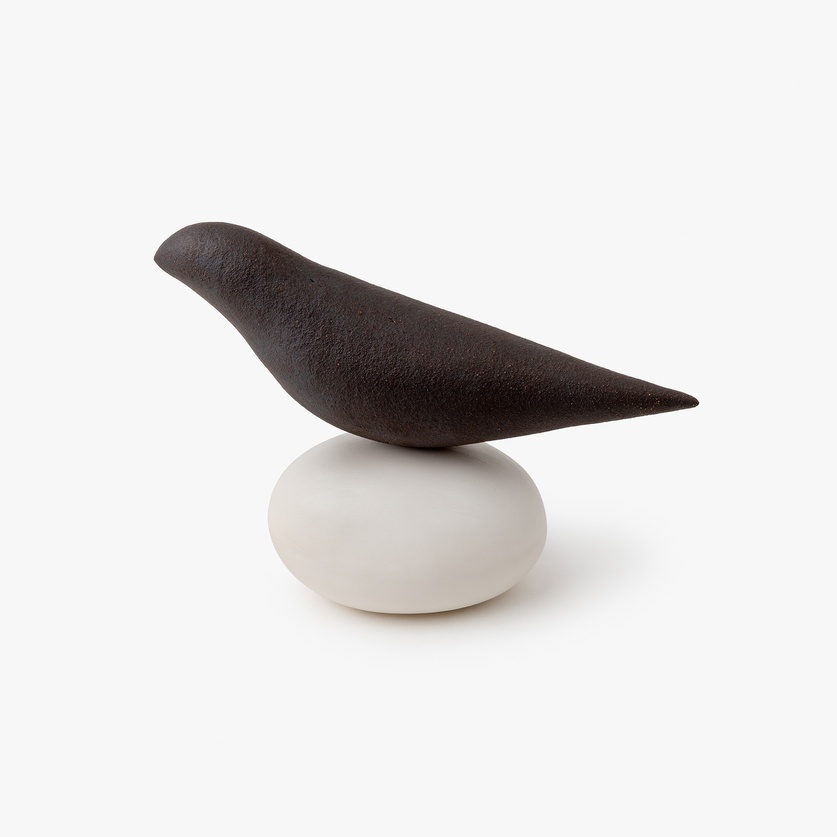 Little ceramic bird on a porcelain base