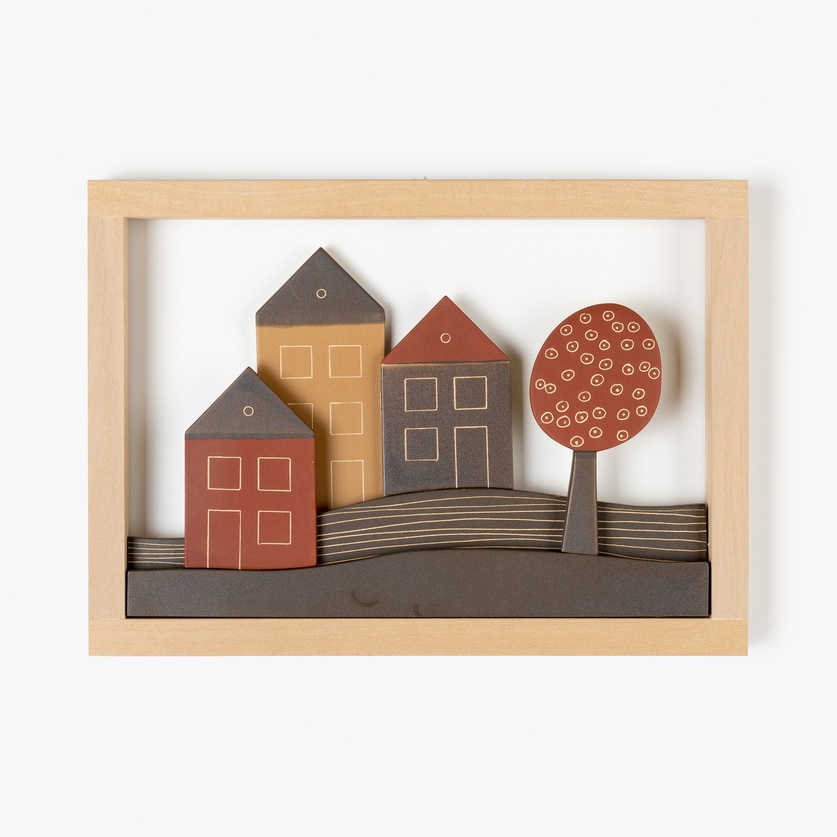 Wall piece with houses and a tree