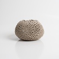 Perforated beige candle holder