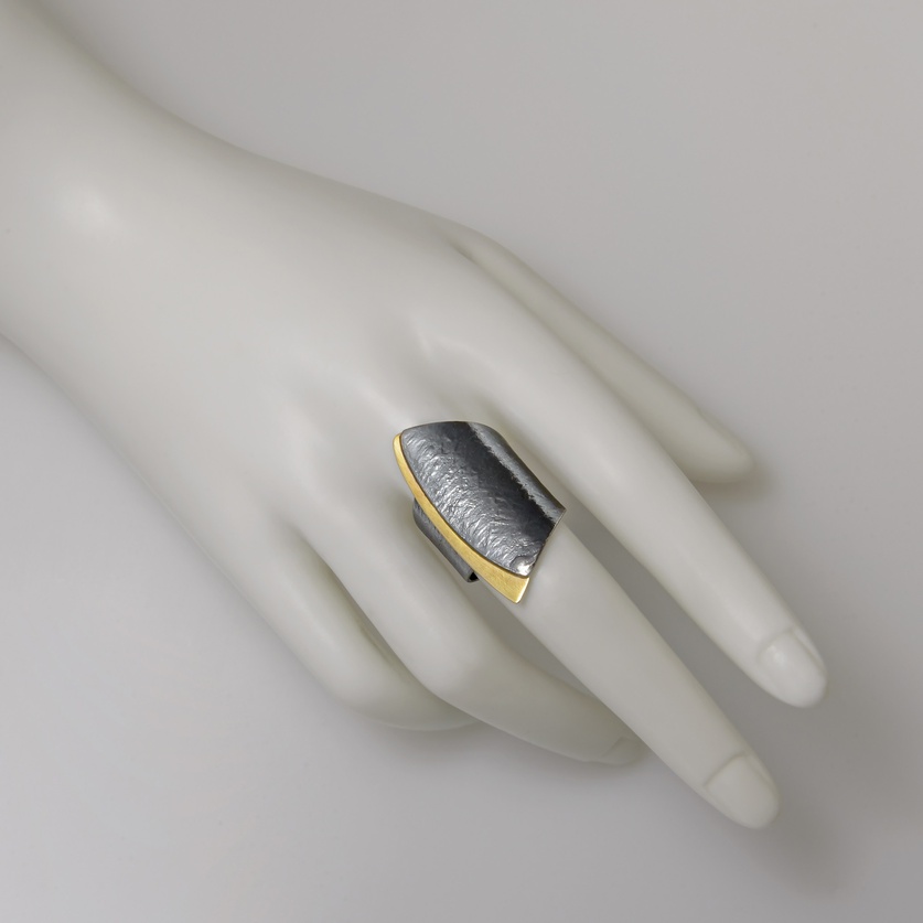 Silver ring in modern style with gold inlay