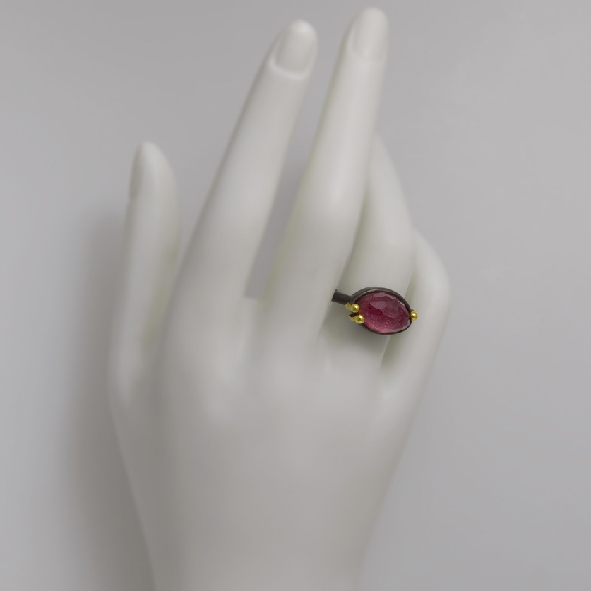 Oval-shaped silver ring with gold and ruby doublet stone