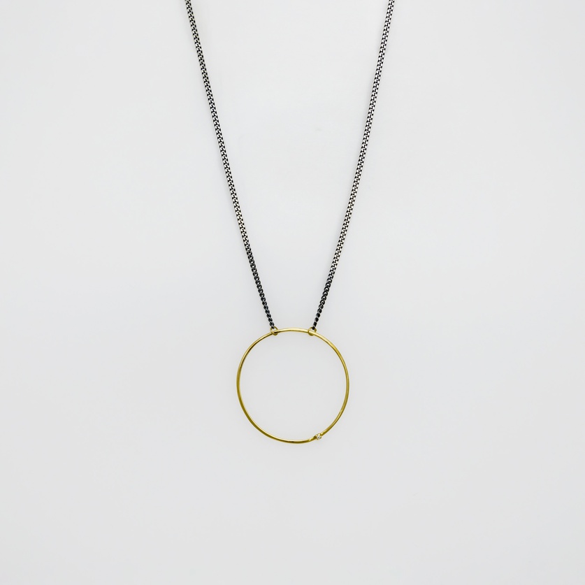 Round gold pendant with brilliant-cut diamond on silver chain (medium size)
