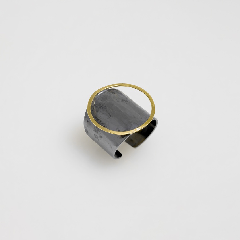 Black silver ring of modern design with circle of gold