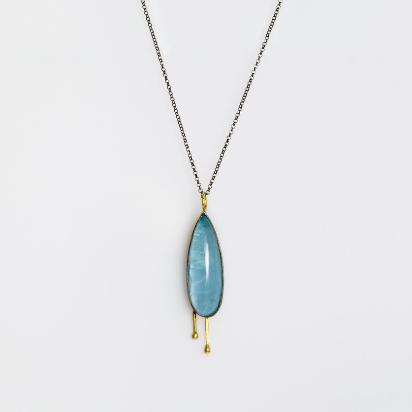 Silver pendant with details in gold and aquamarine