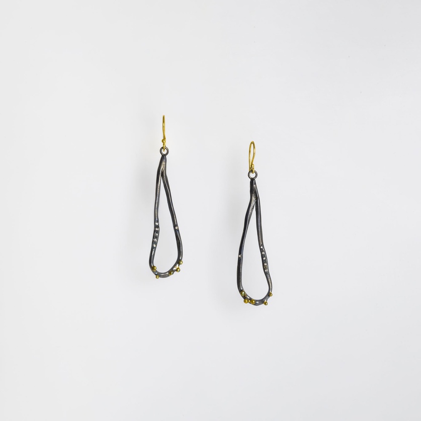 Abstract-shaped earrings in silver and gold with diamonds