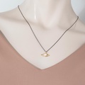Gold “eye” necklace with pearl