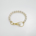 White pearl bracelet with distinctive golden clasp