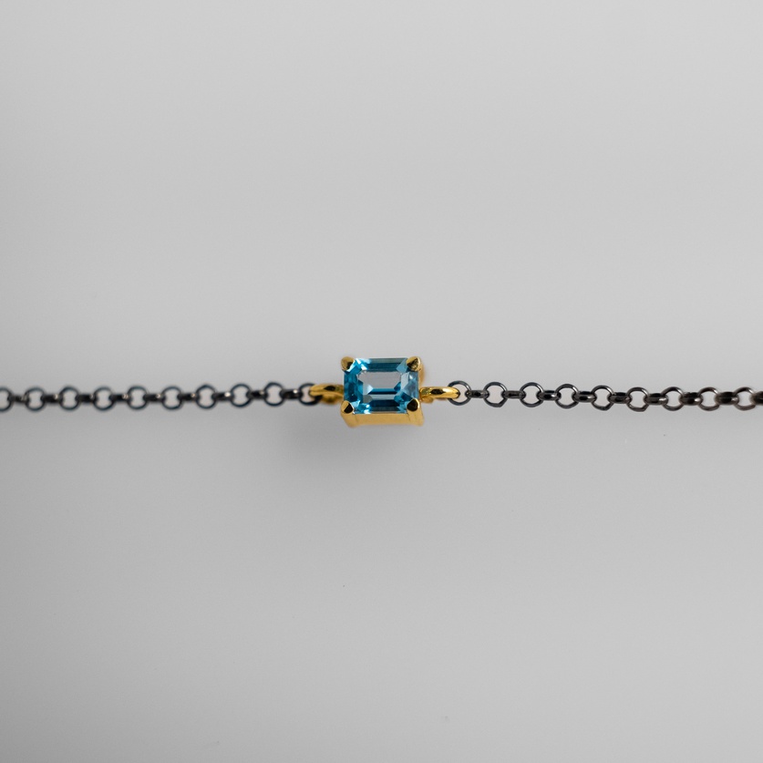 Bracelet in silver and gold with blue topaz