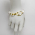 White pearl bracelet with distinctive golden clasp