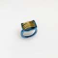 Modern ring in light blue titanium and gold