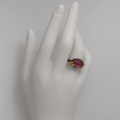 Oval-shaped silver ring with gold and ruby doublet stone