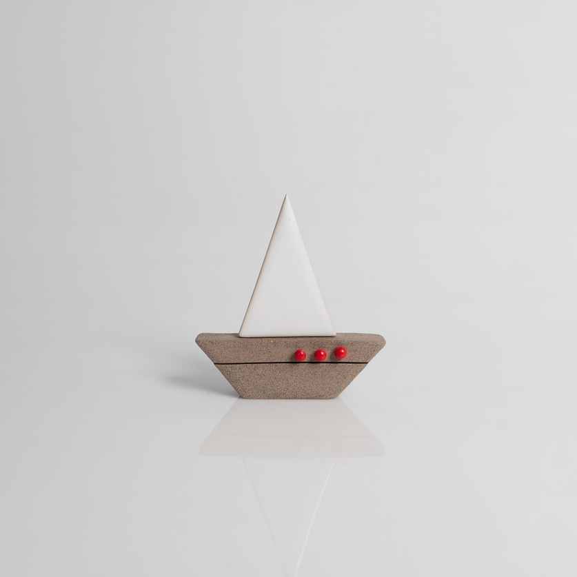 Ceramic sailboat with white sail