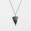 Silver pendant of modern design with gold inlay and ruby on the edge
