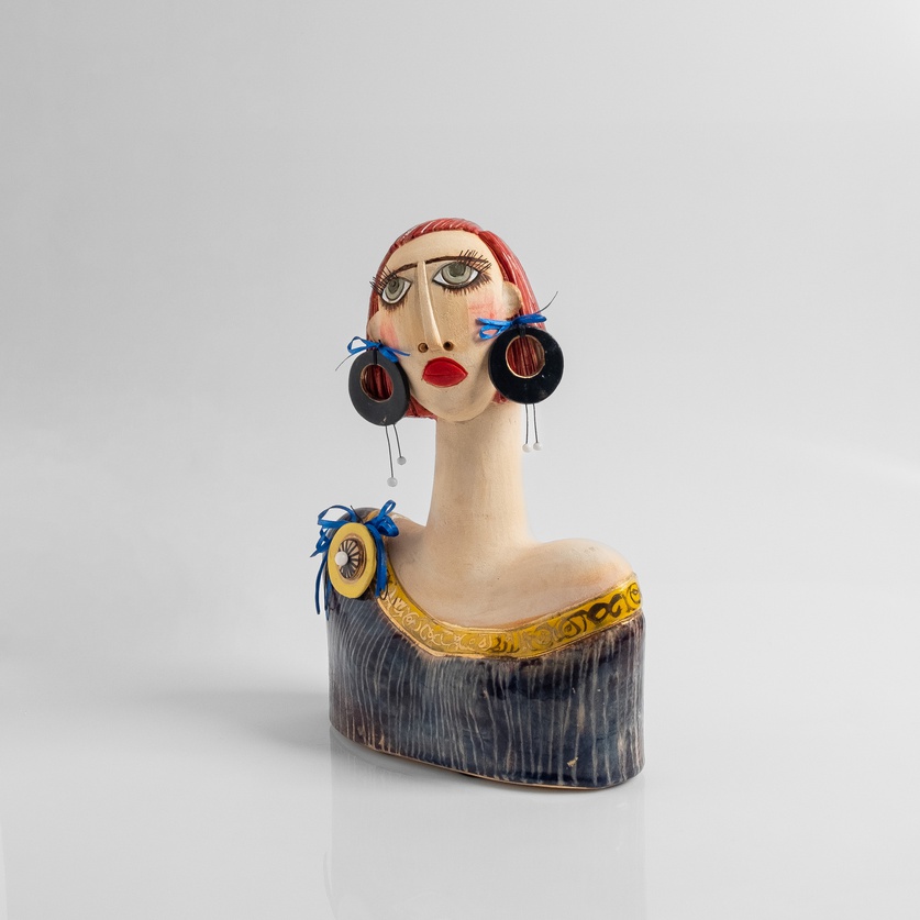 Modern woman with striking earrings and long eyelashes