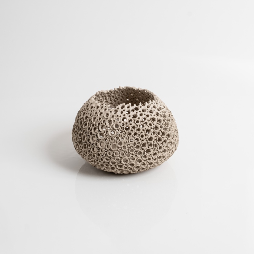 Perforated beige candle holder