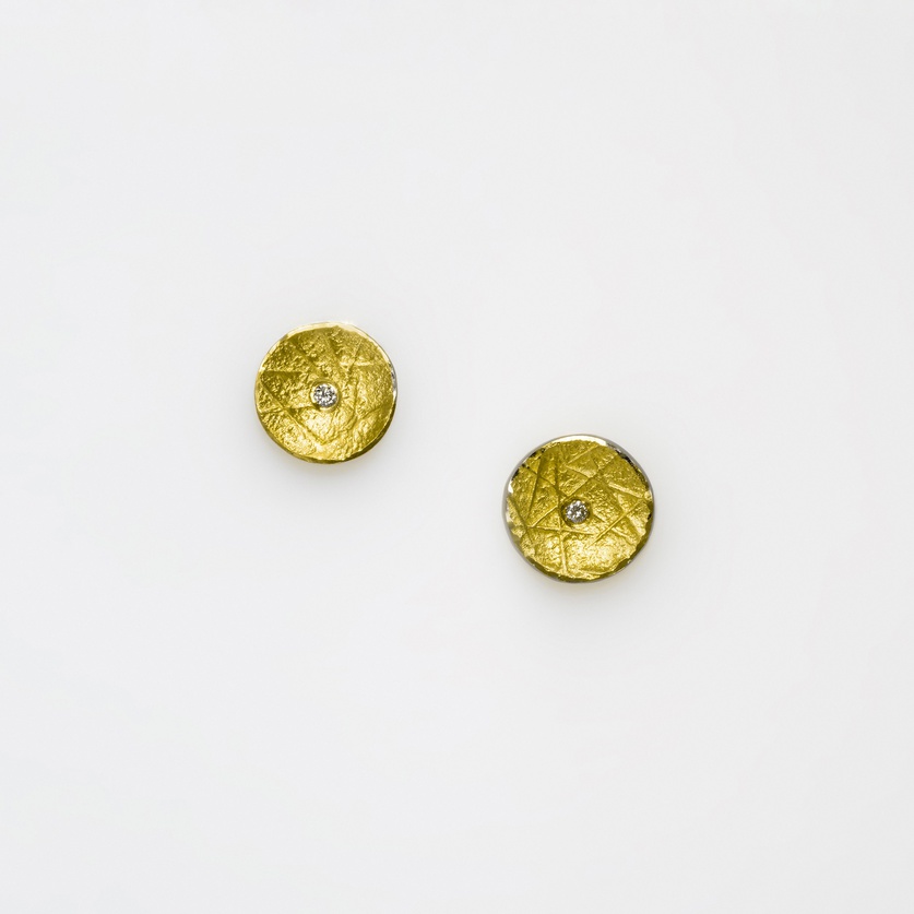 Round stud earrings in silver and gold with small diamonds