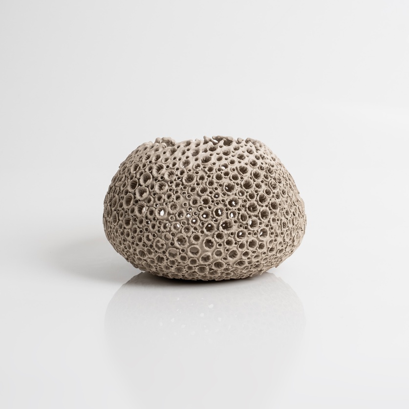 Perforated beige candle holder