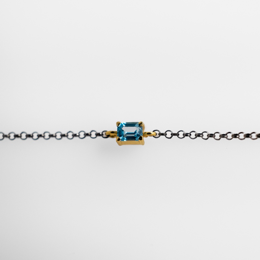 Bracelet in silver and gold with blue topaz