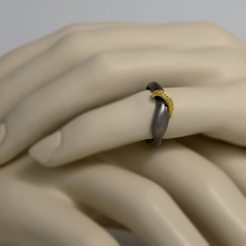 Modern silver ring with gold stripe and diamonds