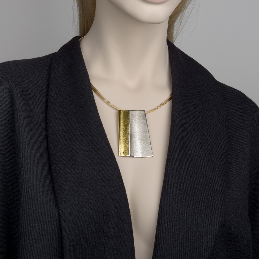 Modern silver necklace with gold inlay and a small diamond