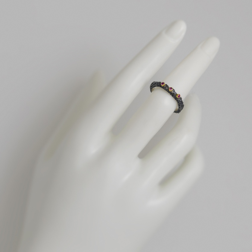 Elegant silver ring with gold bezel set rubies